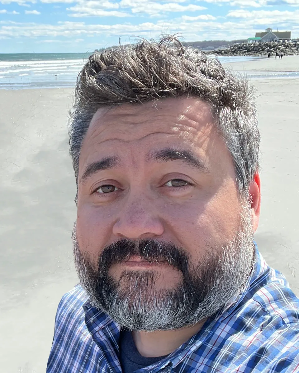 Alan Hopkins on a beach
